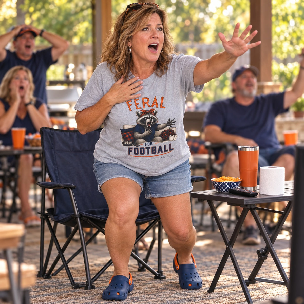 Woman wearing a Feral for Auburn football shirt at an outdoor game day watch party