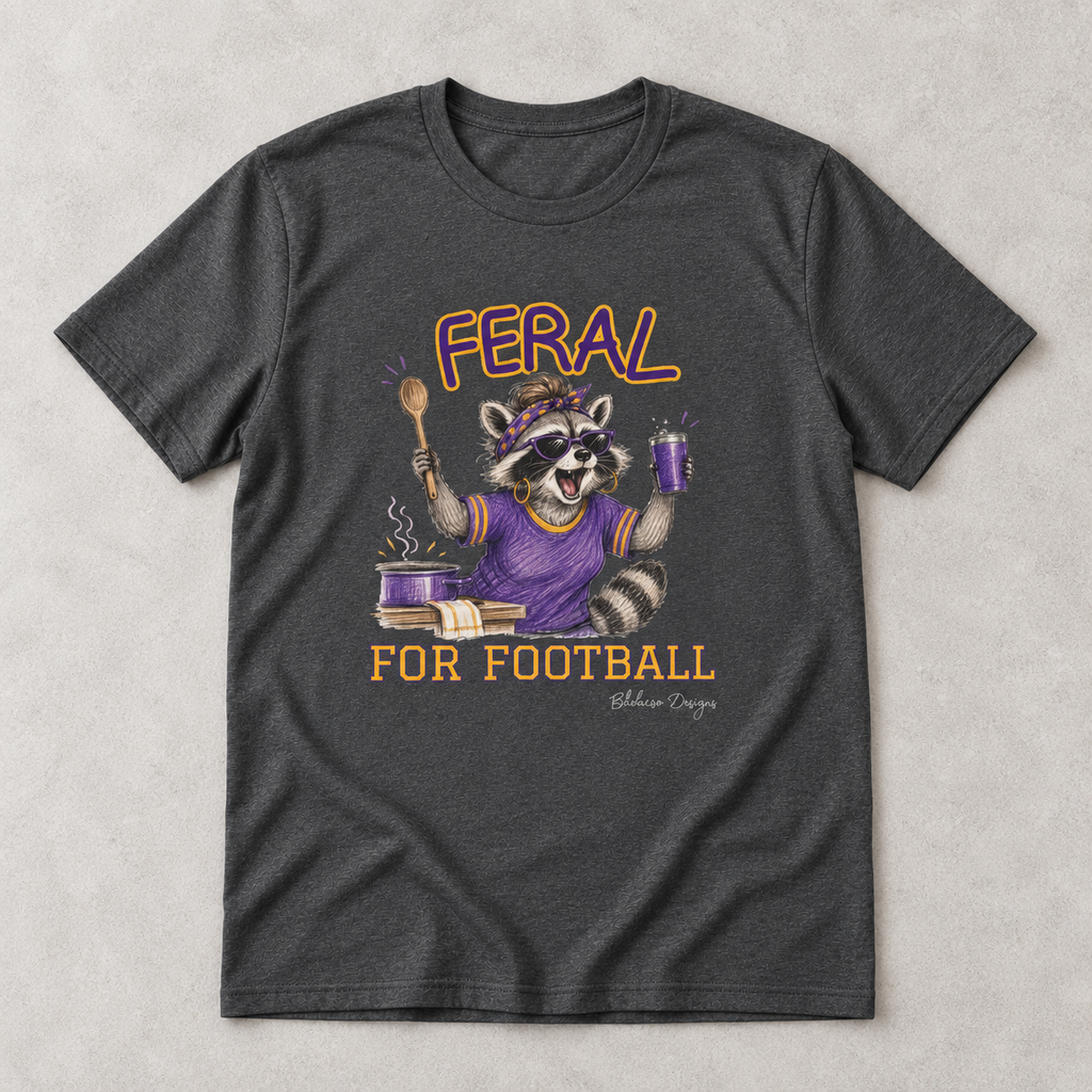 Dark heather Feral for Football LSU T shirt flat lay featuring a purple and gold raccoon game day design.