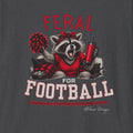 Close up of Feral for Football Georgia raccoon shirt design in red, white, black, and graphite style on a dark heather T shirt.