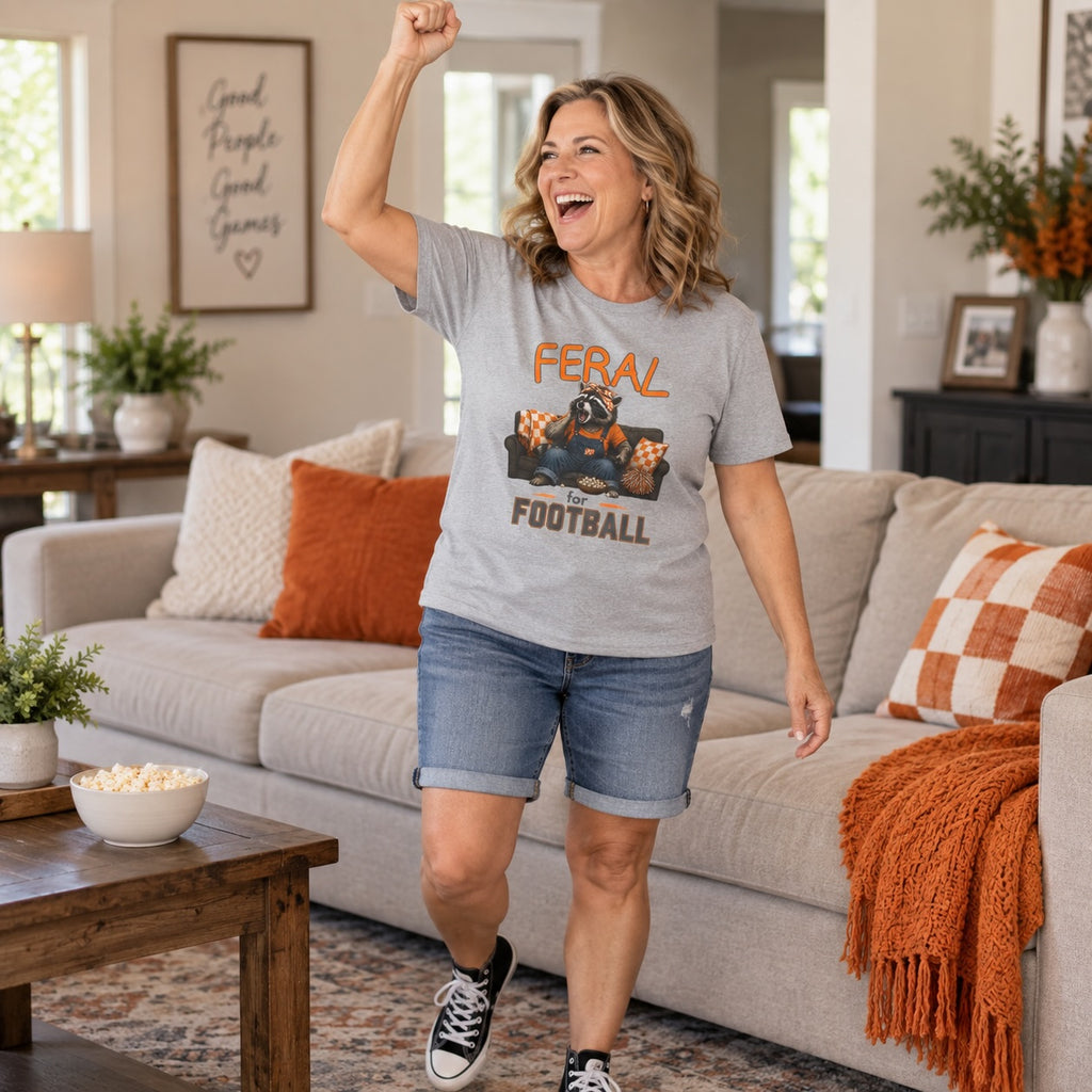 Woman wearing a Feral for Tennessee raccoon shirt during a football watch party.
