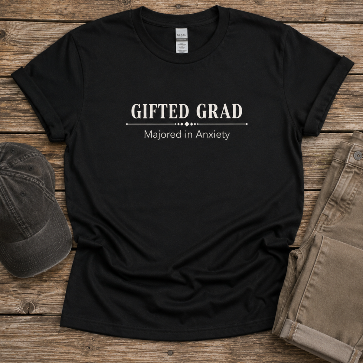 Black Gifted Grad Majored in Anxiety unisex shirt displayed on a rustic wood surface.