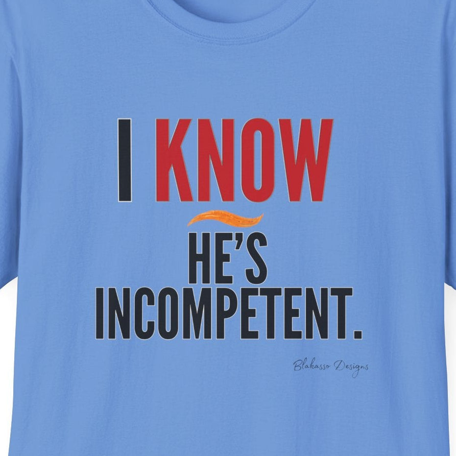 Closeup of the I Know He’s Incompetent shirt design with red KNOW and an orange swoop on Carolina Blue.
