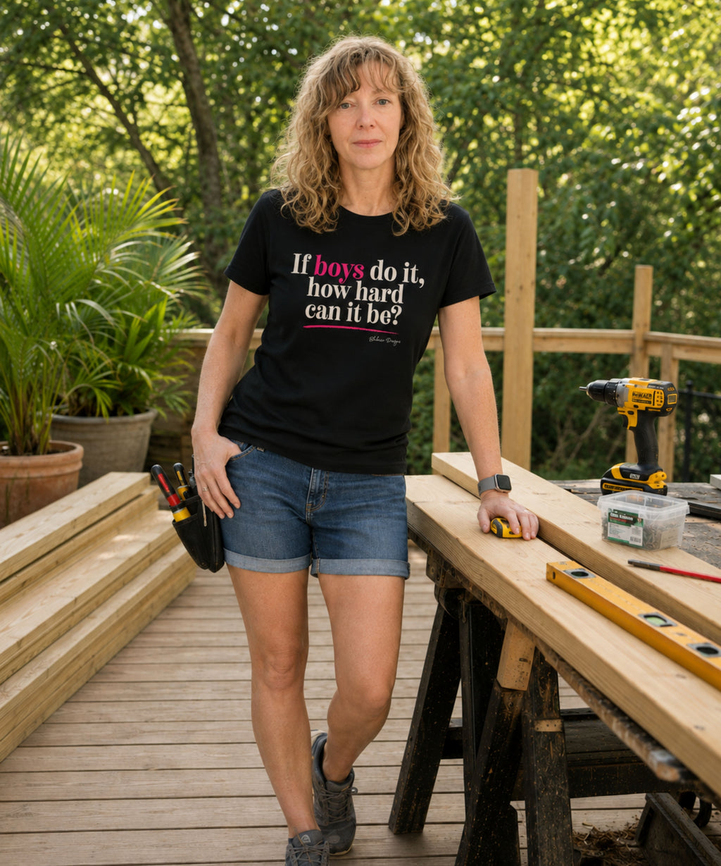 Woman wearing black If Boys Do It How Hard Can It Be shirt while working on an outdoor deck project