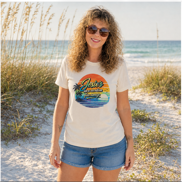 Woman wearing the “Josie’s on a Vacation Far Away” retro music graphic tee with a colorful tropical sunset design.