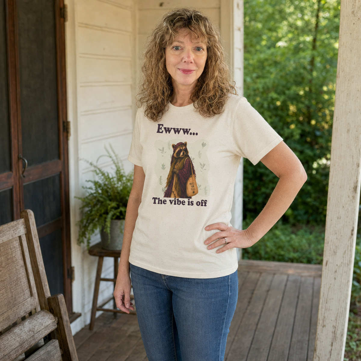 Woman wearing The Vibe Is Off Diana raccoon graphic tee with a protect your peace theme.