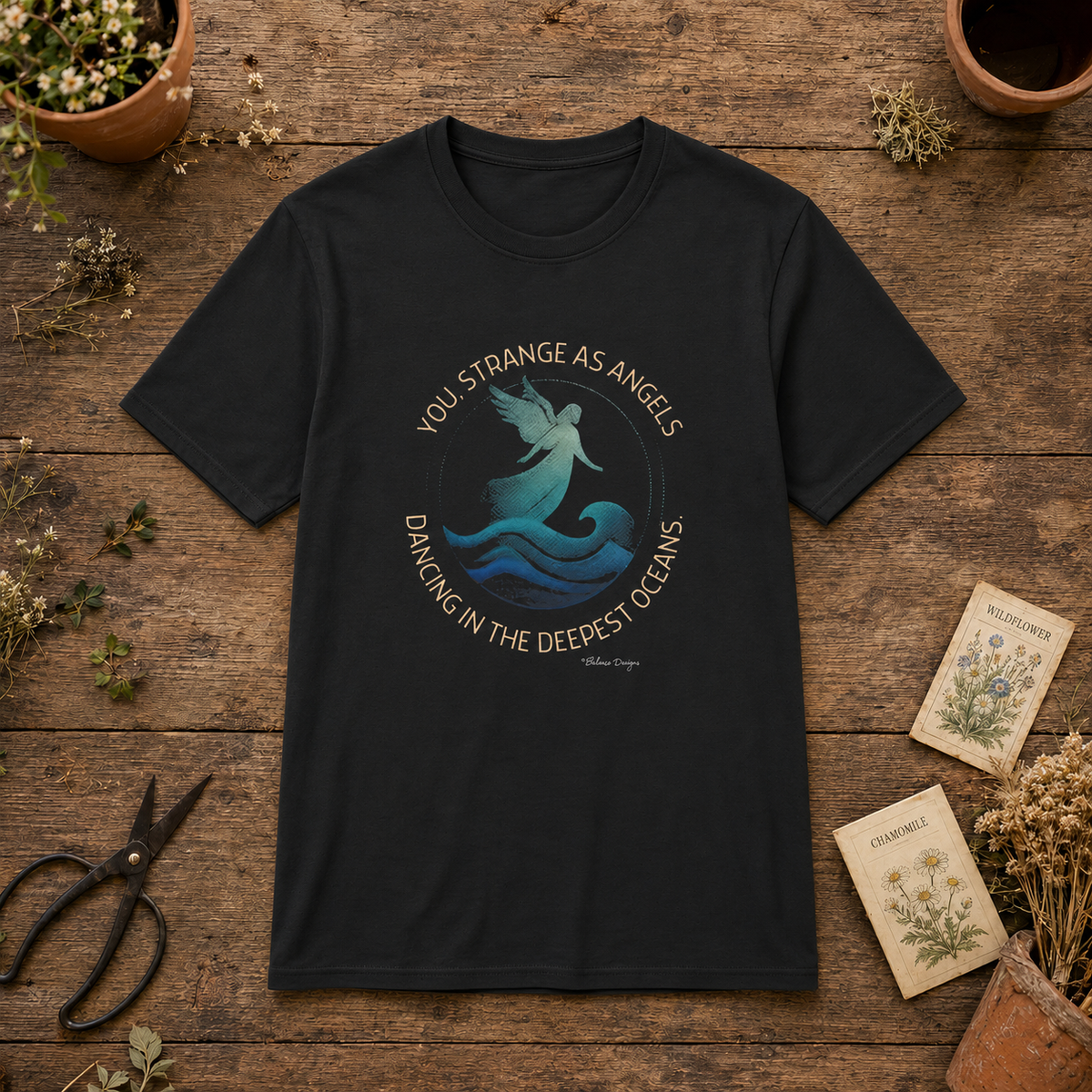 You Strange as Angels ocean angel unisex graphic tee flat lay