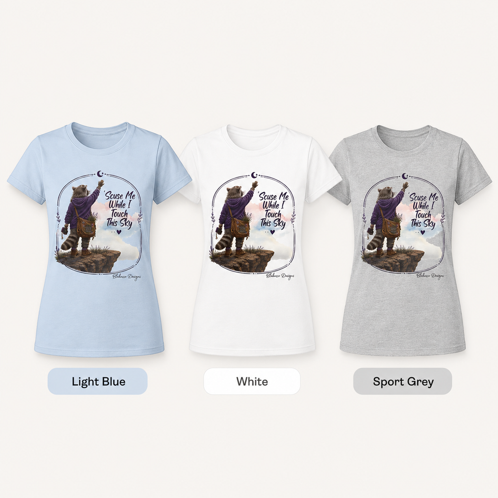 Scuse Me While I Touch This Sky women’s raccoon graphic T-shirt shown in Light Blue, White, and Sport Grey.