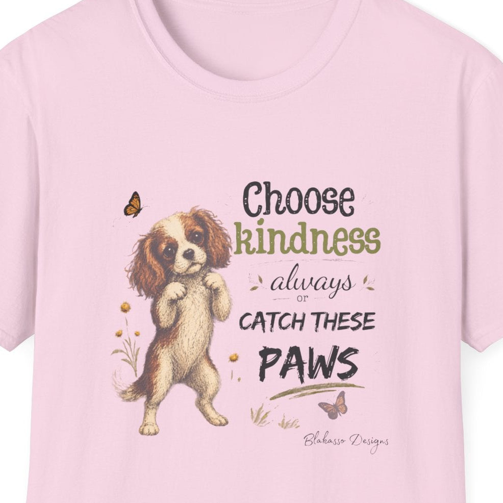 Close-up of Choose Kindness Always or Catch These Paws puppy artwork on a light pink T-shirt.