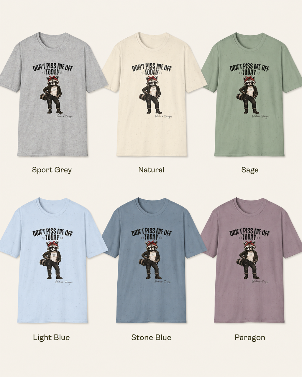 Color options for the "Don't Piss Me Off Today" Maddelynn raccoon graphic tee by Blakasso Designs. T-shirt shown in Sport Grey, Natural, Sage, Light Blue, Stone Blue, and Paragon.