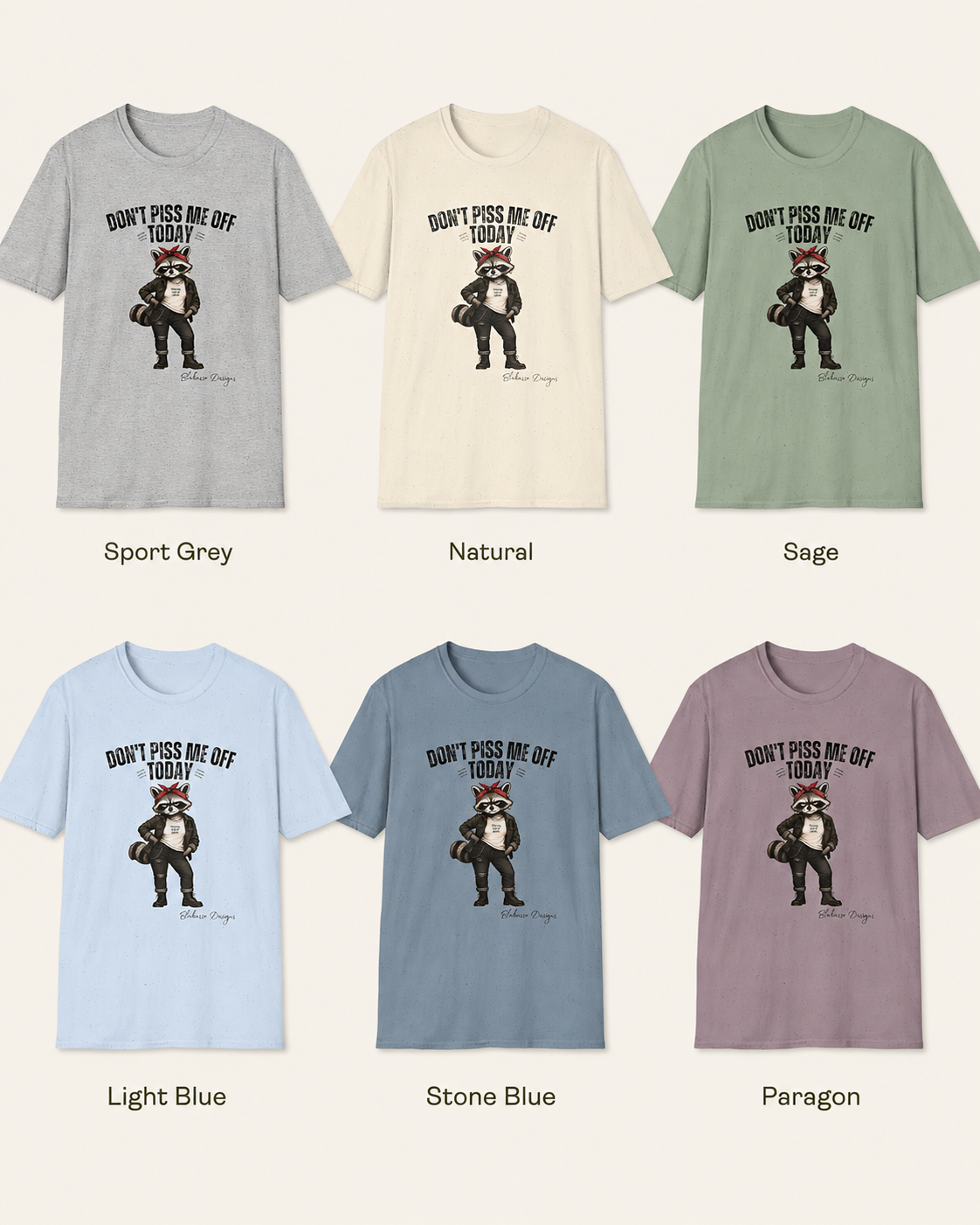 Color options for the "Don't Piss Me Off Today" Maddelynn raccoon graphic tee by Blakasso Designs. T-shirt shown in Sport Grey, Natural, Sage, Light Blue, Stone Blue, and Paragon.