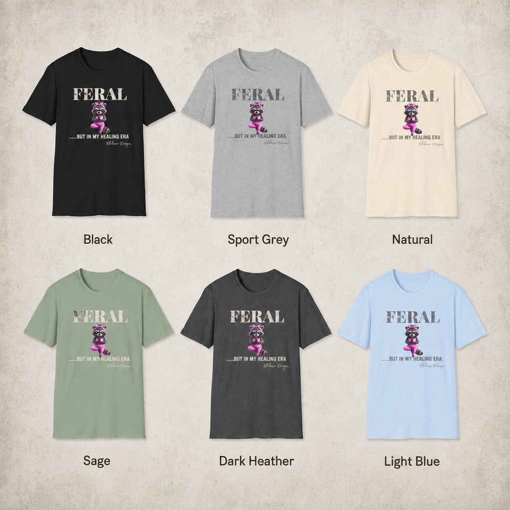 Available shirt colors for the “Feral...But In My Healing Era” raccoon graphic tee by Blakasso Designs.