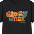 Close-up of the Groovy Witch design showing wavy retro lettering, warm earthy colors, floral accents, and distressed vintage texture.