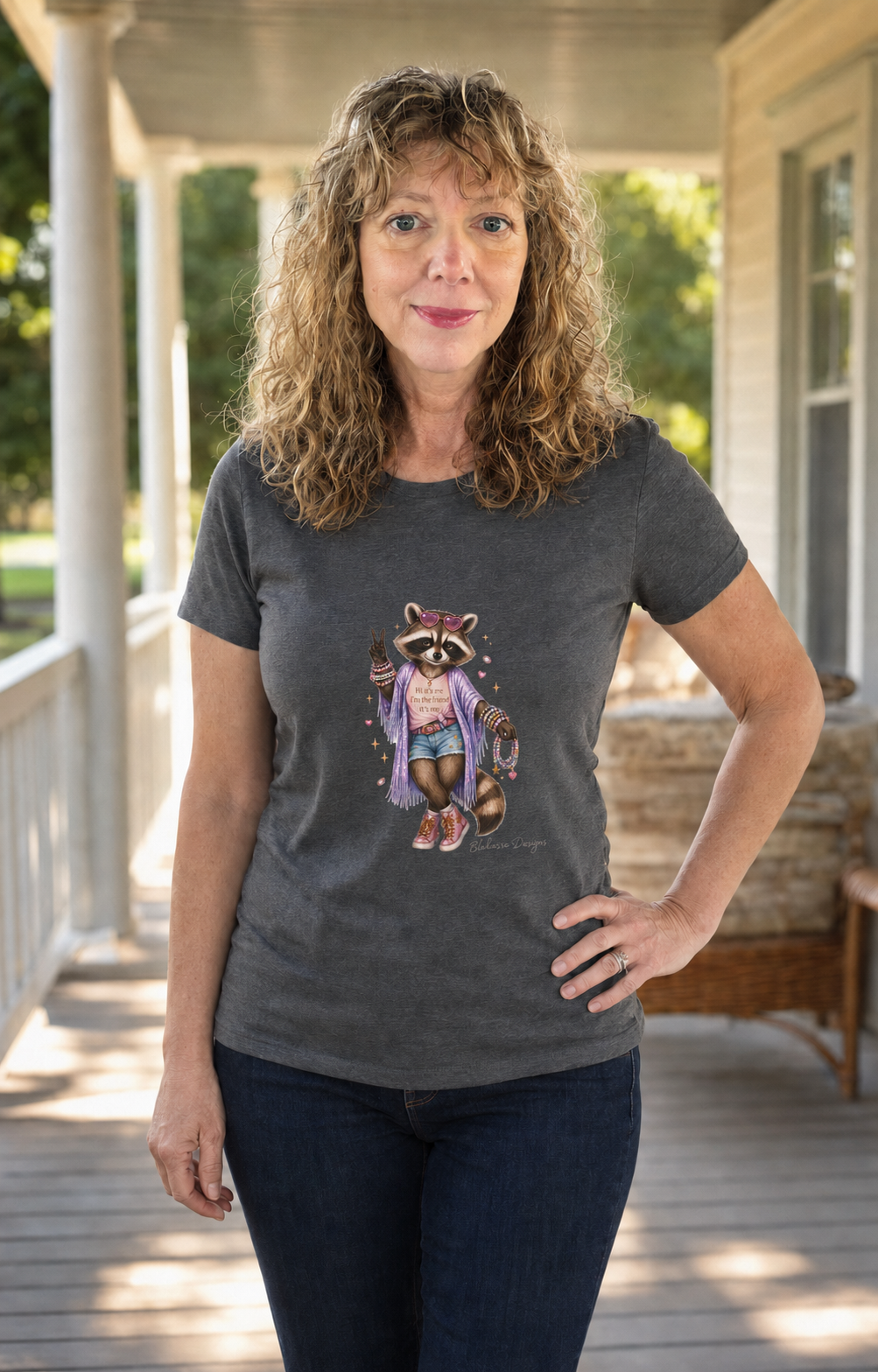 Woman wearing the “Hi It’s Me I’m the Friend It’s Me” LouLou raccoon graphic tee inspired by music, concerts, and friendship bracelets.