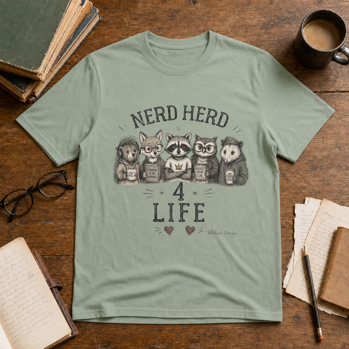Sage Nerd Herd 4 Life graphic tee featuring an illustrated hedgehog, fox, raccoon, owl, and opossum celebrating readers, thinkers, and trivia lovers.