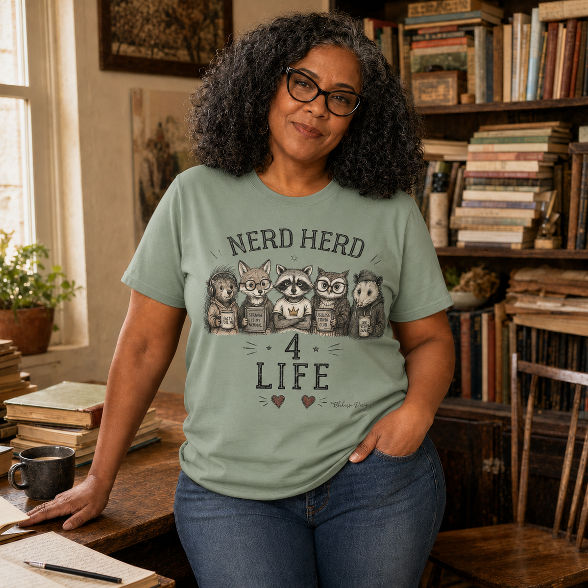 Lifestyle image featuring the sage Nerd Herd 4 Life woodland animal graphic tee by Blakasso Designs.