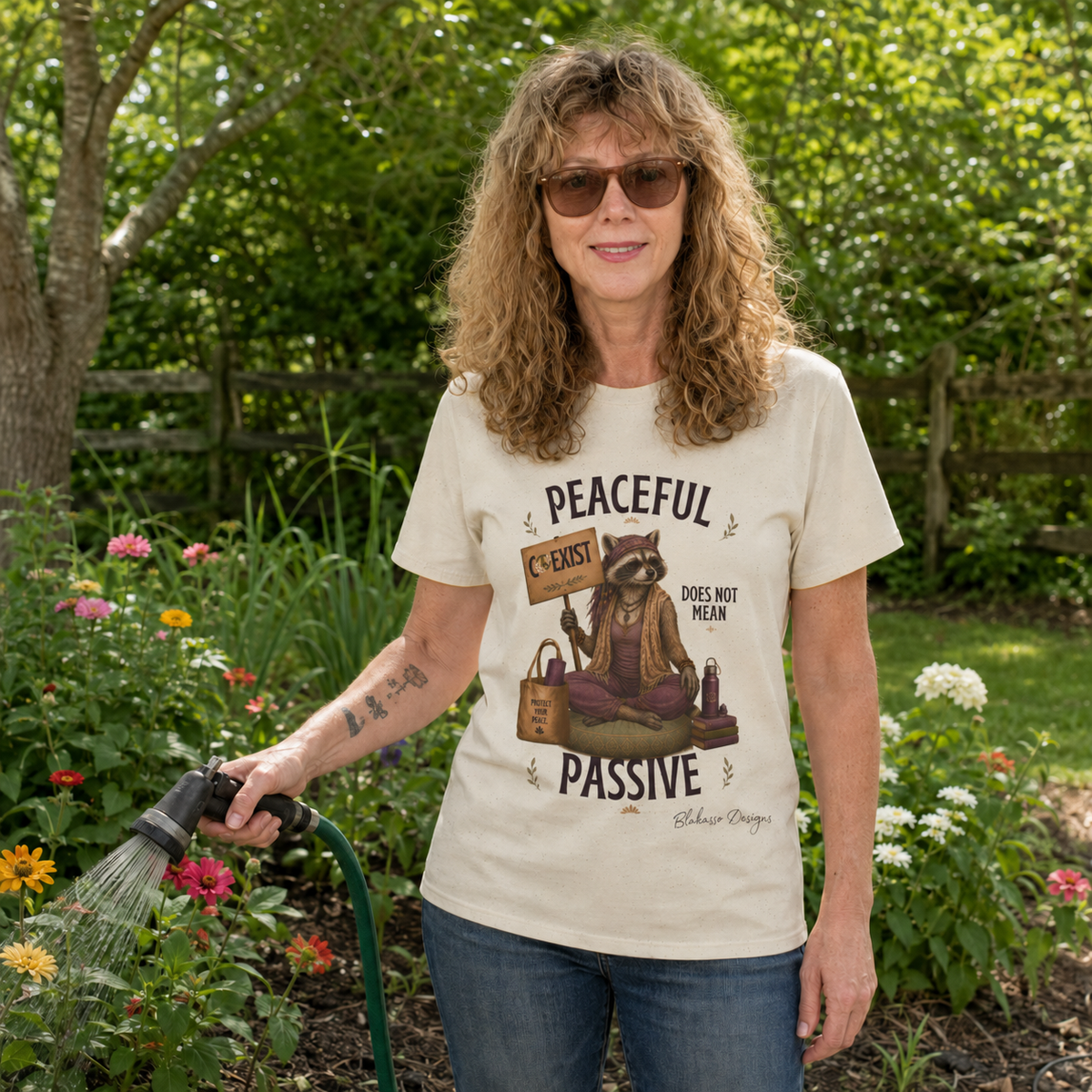 Model wearing the "Peaceful Does Not Mean Passive" Diana raccoon graphic tee celebrating healthy boundaries, kindness, and protecting your peace.