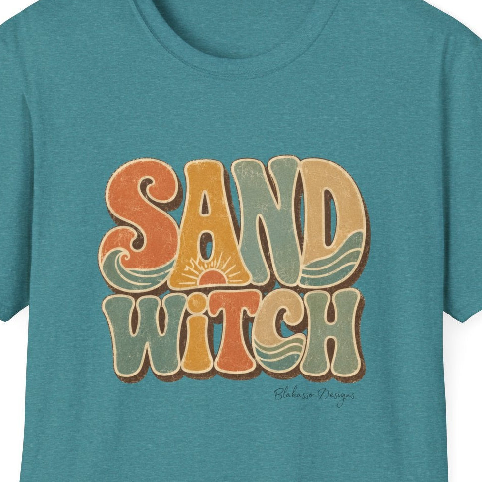 Close-up of the Sand Witch design showing distressed retro lettering, sun details, wave accents, and warm coastal colors.