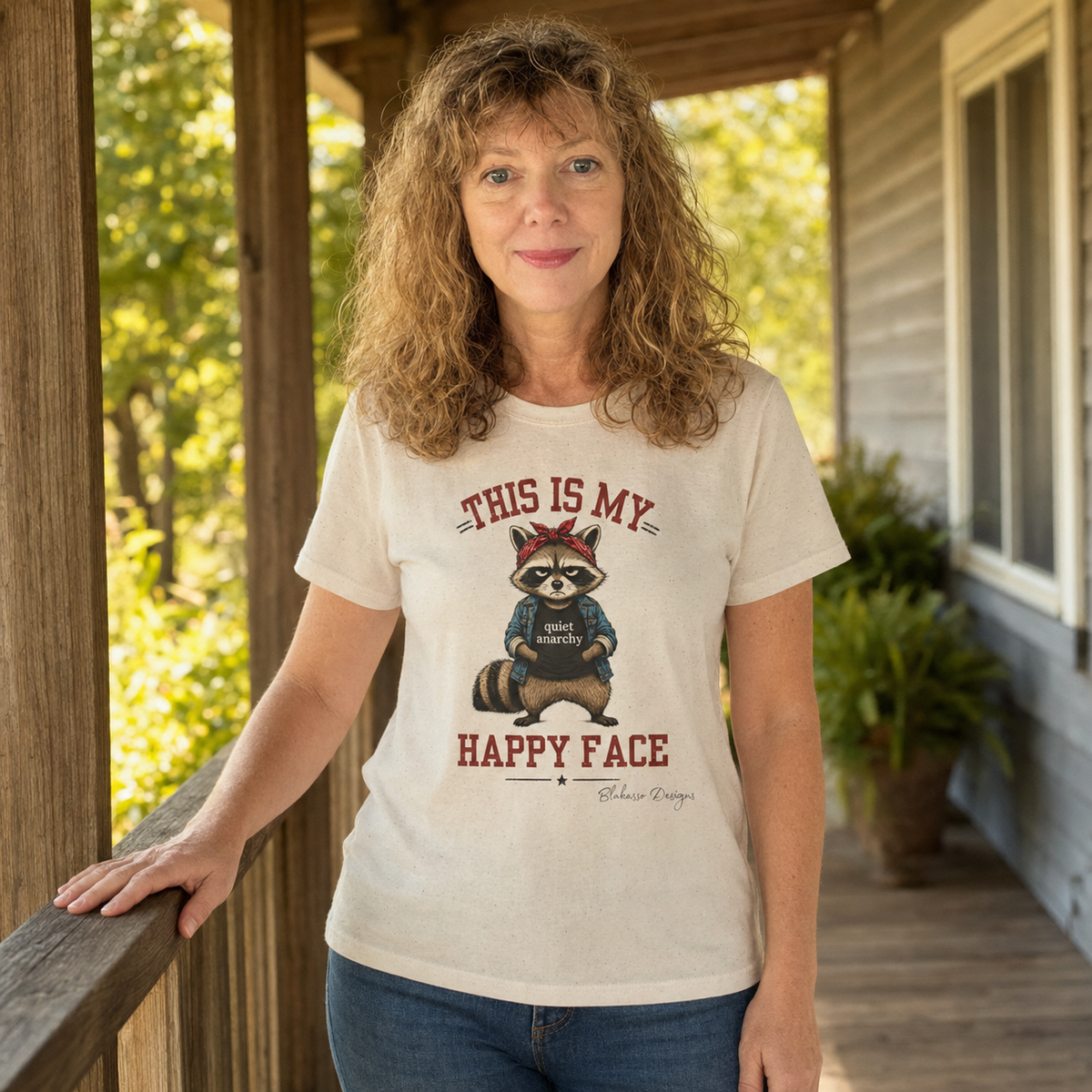Person wearing the “This Is My Happy Face” raccoon graphic tee featuring a sarcastic woodland animal design.